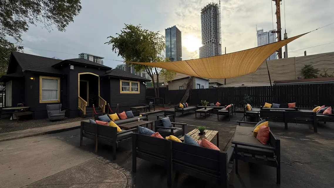 Garden courtyard seating at Elsewhere Hookah Lounge with downtown Austin skyline